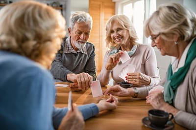 Seniors enjoying a card game at a table