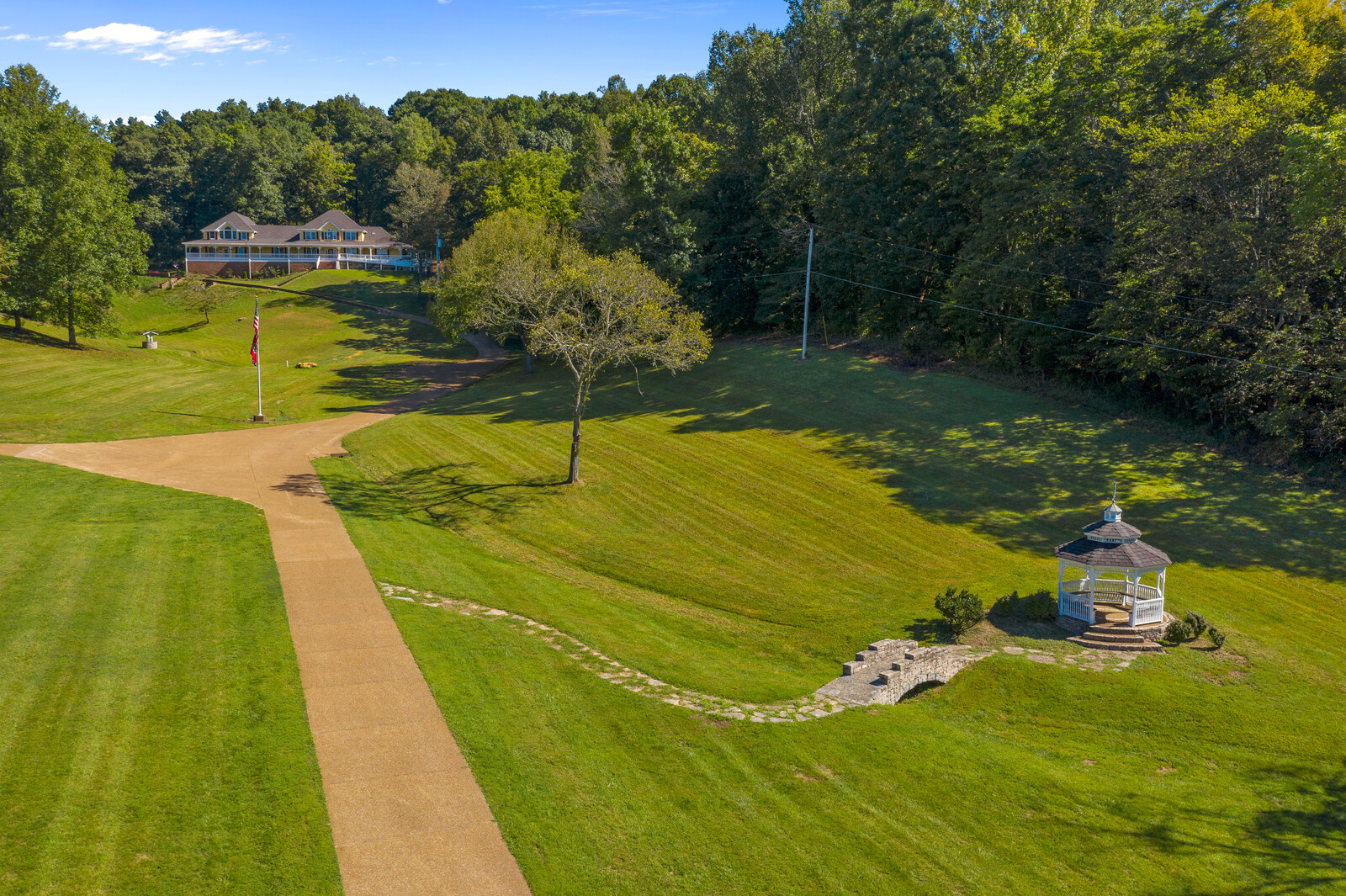 Aerial view of landscaped grounds with gazebo and facility in the background.