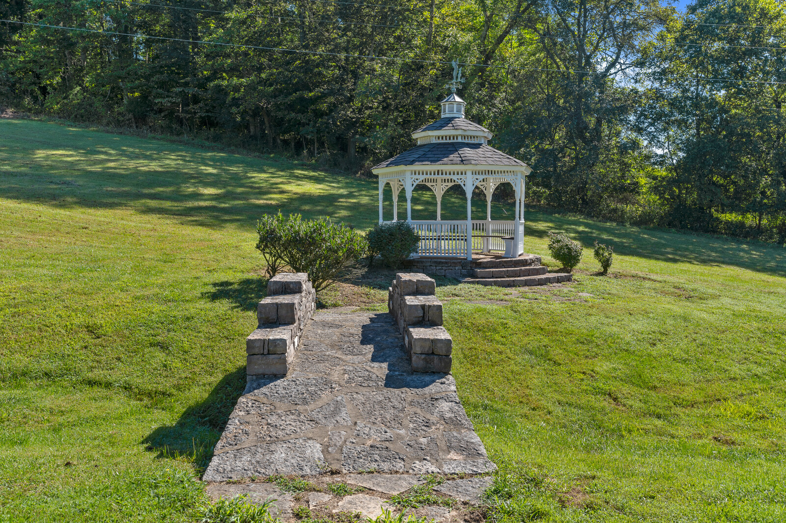 A gazebo in a green outdoor space