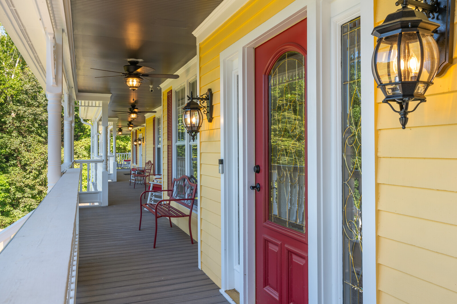 Exterior porch area with yellow walls and seating