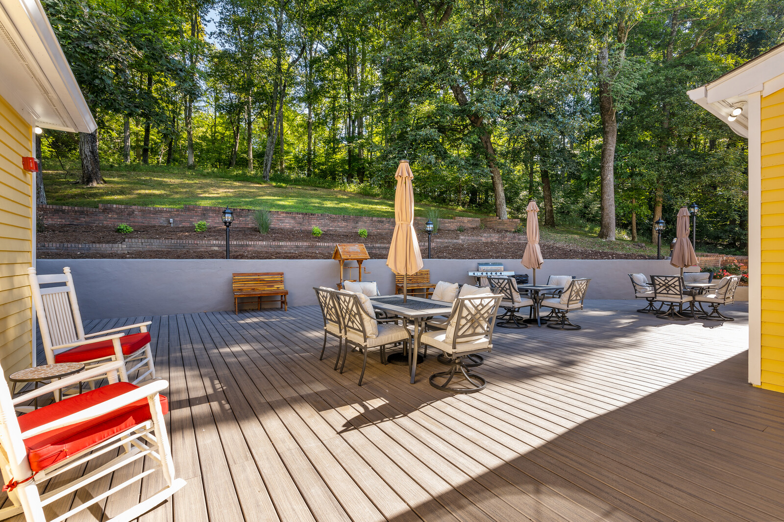 Outdoor patio area with seating and trees in the background