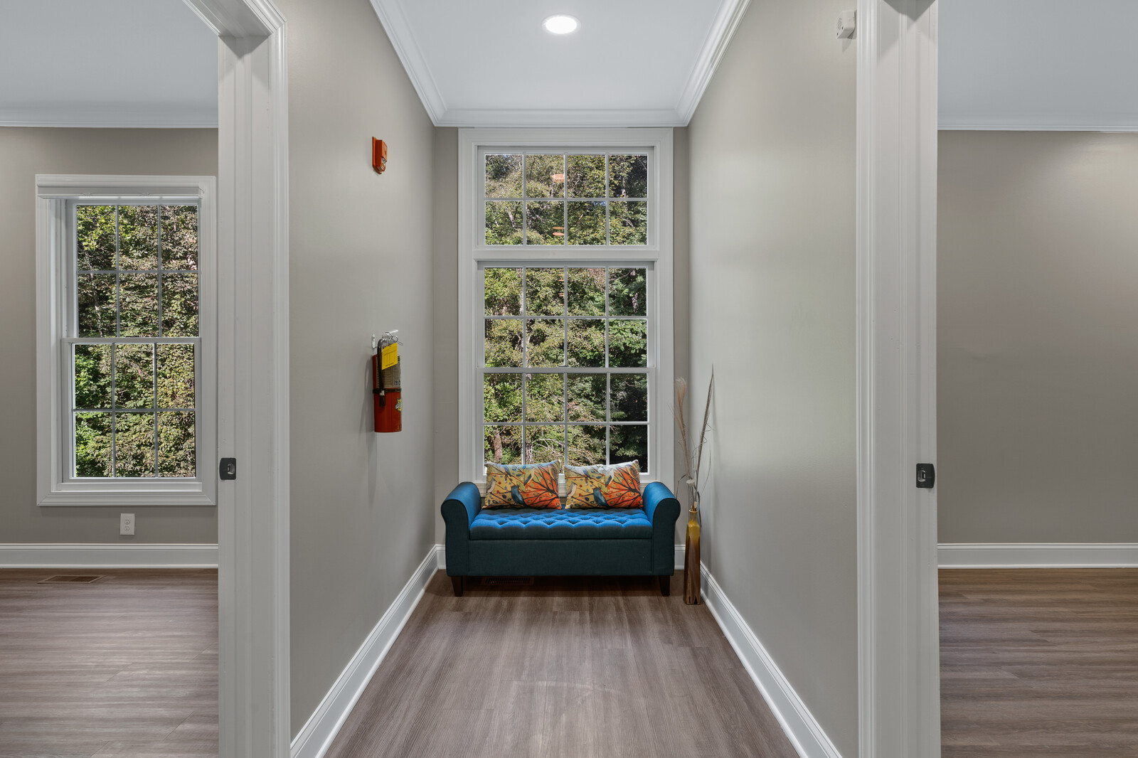 Hallway with a couch and large windows