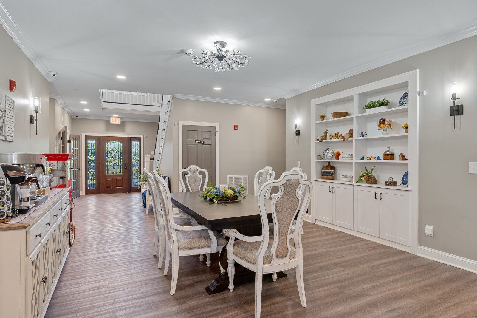 Common area with a dining table and decorative shelves