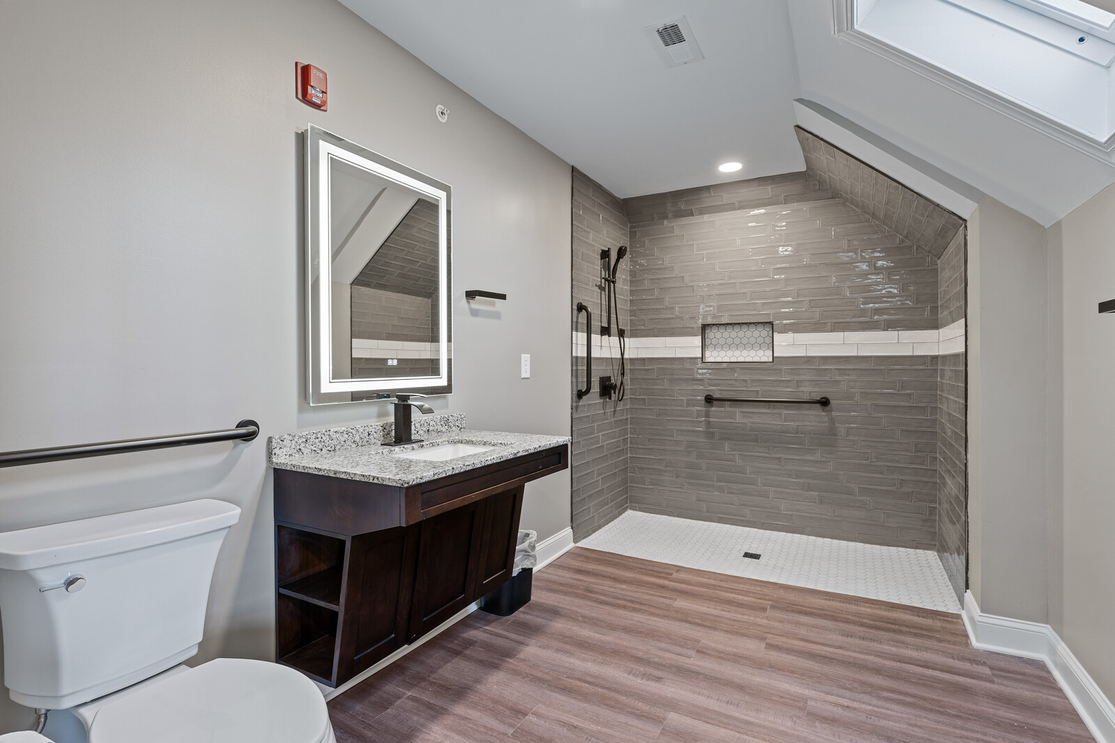 Accessible bathroom with modern fixtures and a large mirror