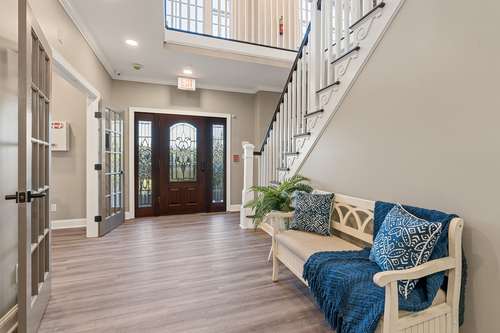 Bright entryway of a senior living facility with seating area