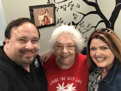 Residents and staff smiling together in an indoor setting