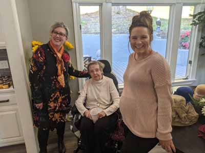 Residents and staff smiling in a common area