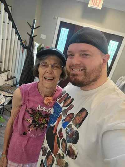 A resident and a staff member smiling indoors