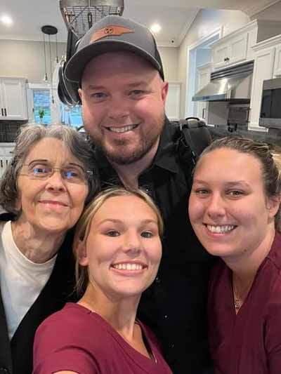 Residents and staff posing for a selfie in the kitchen