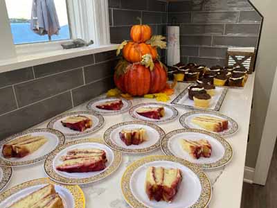 A table with cakes and pumpkins in a festive kitchen setting
