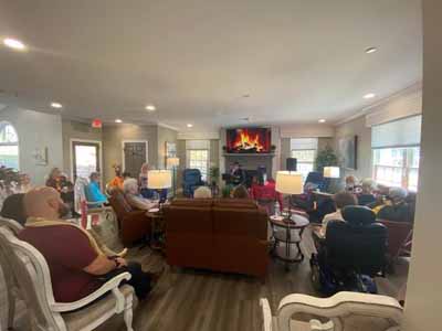 Residents engaged in a group activity in a cozy common area
