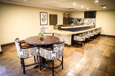 Bright common area with seating and bar counter