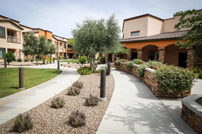 Pathway through landscaped outdoor space at senior living facility