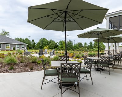 Outdoor seating area with umbrellas and landscaping