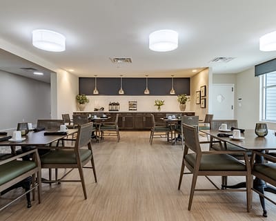 Dining room with tables and chairs set for meals