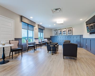 Bright common area with seating and large windows