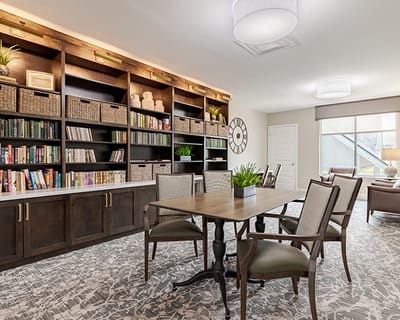 Bright common area with bookshelves and tables