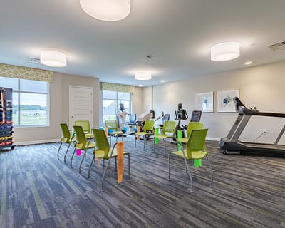 Fitness area with equipment and chairs set up for activity