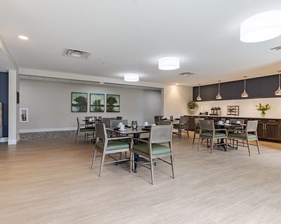 Bright, inviting dining room with tables set for meals
