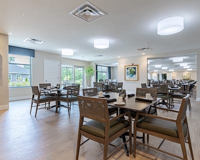Bright dining room with tables set for meals
