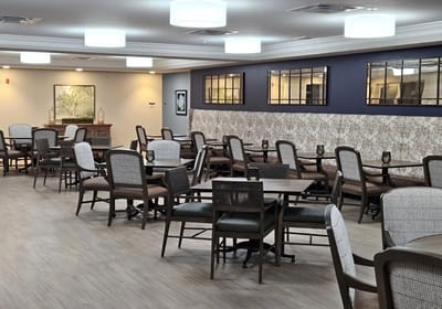 Bright dining area with tables and chairs arranged