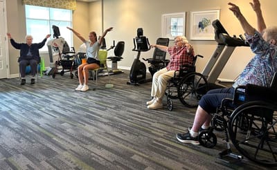 Residents participating in a seated exercise class