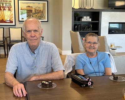 Two residents enjoying dessert in a common area