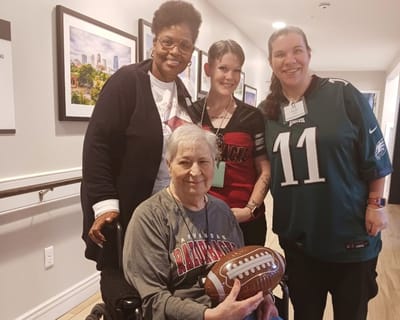 Residents and staff posing together in a common area