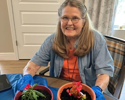 Resident gardening in a vibrant activity room