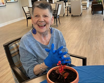Resident engaging in planting activity in a common area