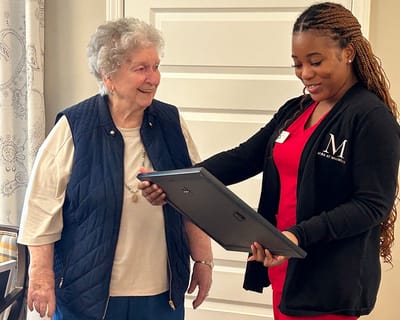 Staff presenting a framed certificate to a resident