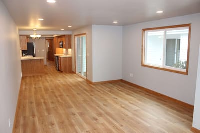 Spacious interior view of a living area with wood flooring