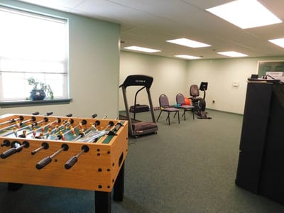 Activity room with foosball table and treadmill