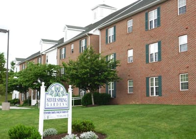 Exterior view of Silver Spring Gardens building with landscaping