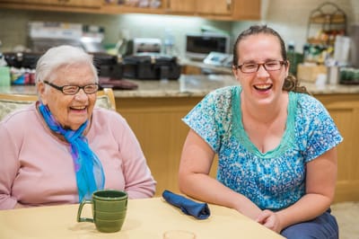 Residents laughing together in a cozy activity space