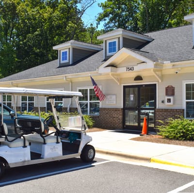Exterior view of assisted living facility with golf cart