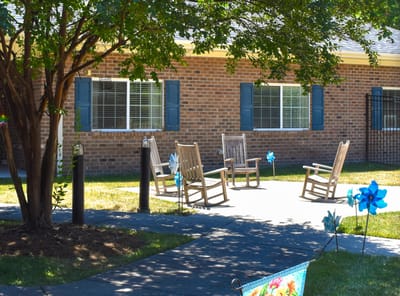 Outdoor seating area with rocking chairs and garden decor