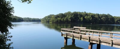 Scenic view of a calm lake with a wooden pier