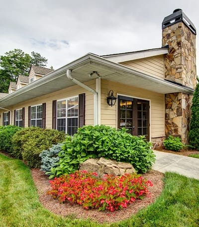 Entrance of a senior living facility with landscaped garden