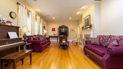 Cozy interior of a common area with seating and piano