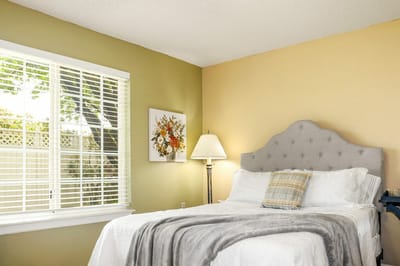 Cozy resident room with a bed and lamp