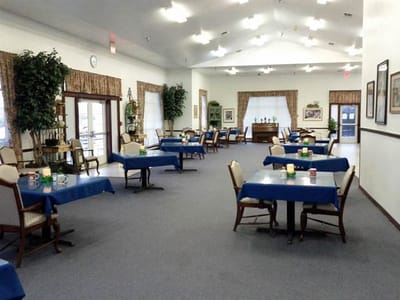 Bright dining area with blue tablecloths and chairs