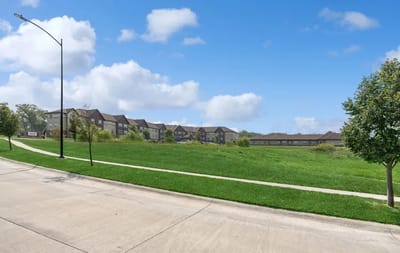 Exterior view of AVIVA Woodlands facility with landscaped grounds