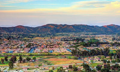 Aerial view of a suburban area with mountains in the background
