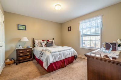 Cozy private resident room with bed and decor