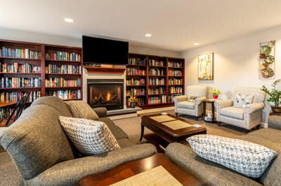 Cozy common area with a fireplace and bookshelves