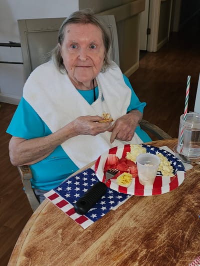 Resident enjoying a meal with festive table decorations