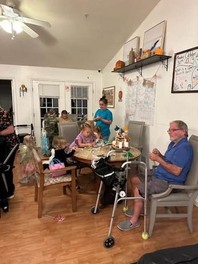 Residents and children engaging in activities in a common area