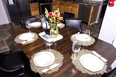 Dining table set for a meal with flowers