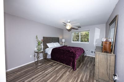 A well-decorated private resident room with a bed and window
